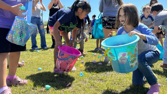 Kids in Tuskahoma picking up Easter eggs.