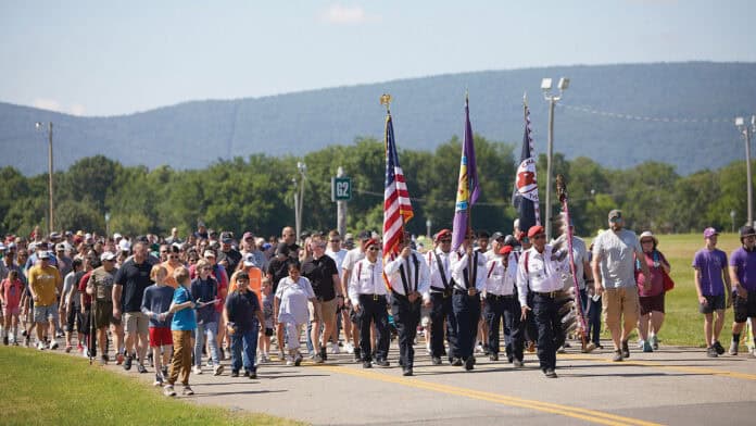 The Choctaw Nation Color Guard lead a large crowd.