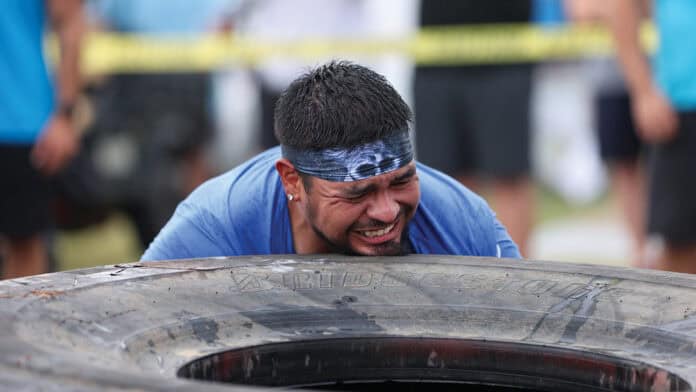 Last year's Tough Tough champion, Matt Harjo, tries to flip the 600lb tire during the 2024 Tough Tough event.